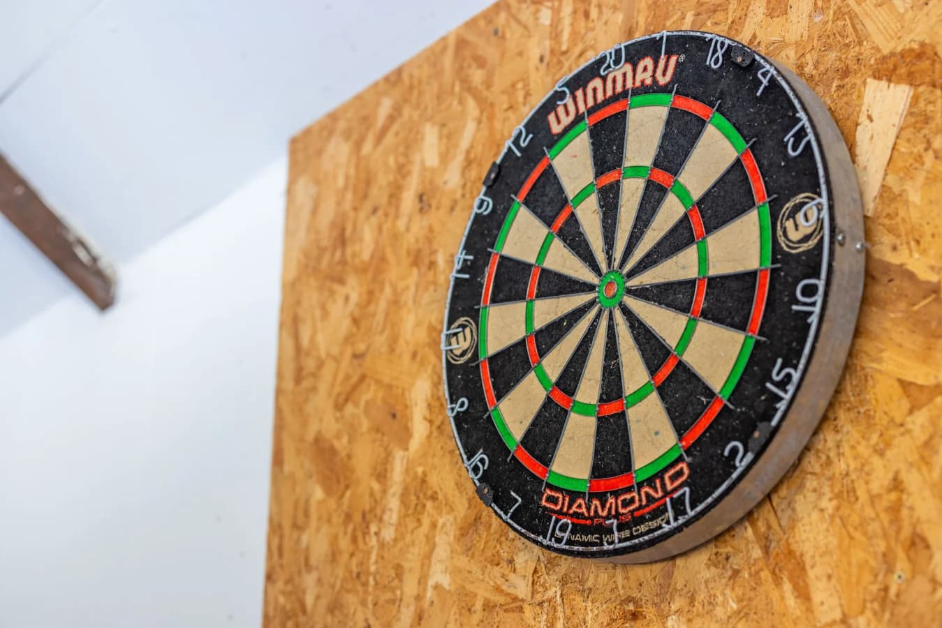 Dartboard mounted within the shared games room