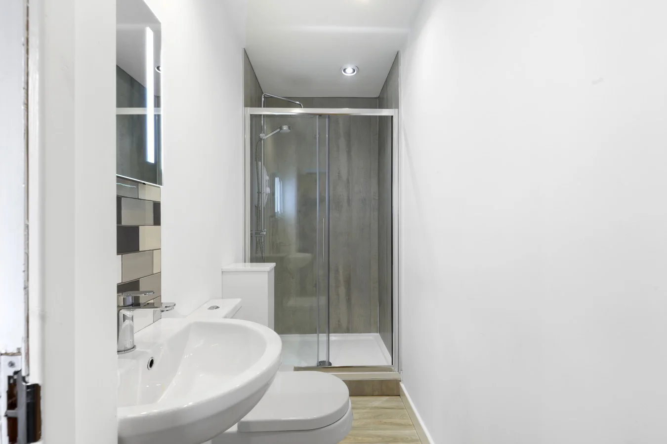 Modern shower room with walk-in enclosure and heated towel rail
