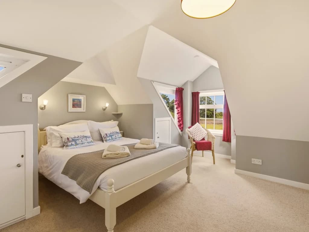 Cosy double bedroom with vaulted ceiling, countryside views and armchair seating