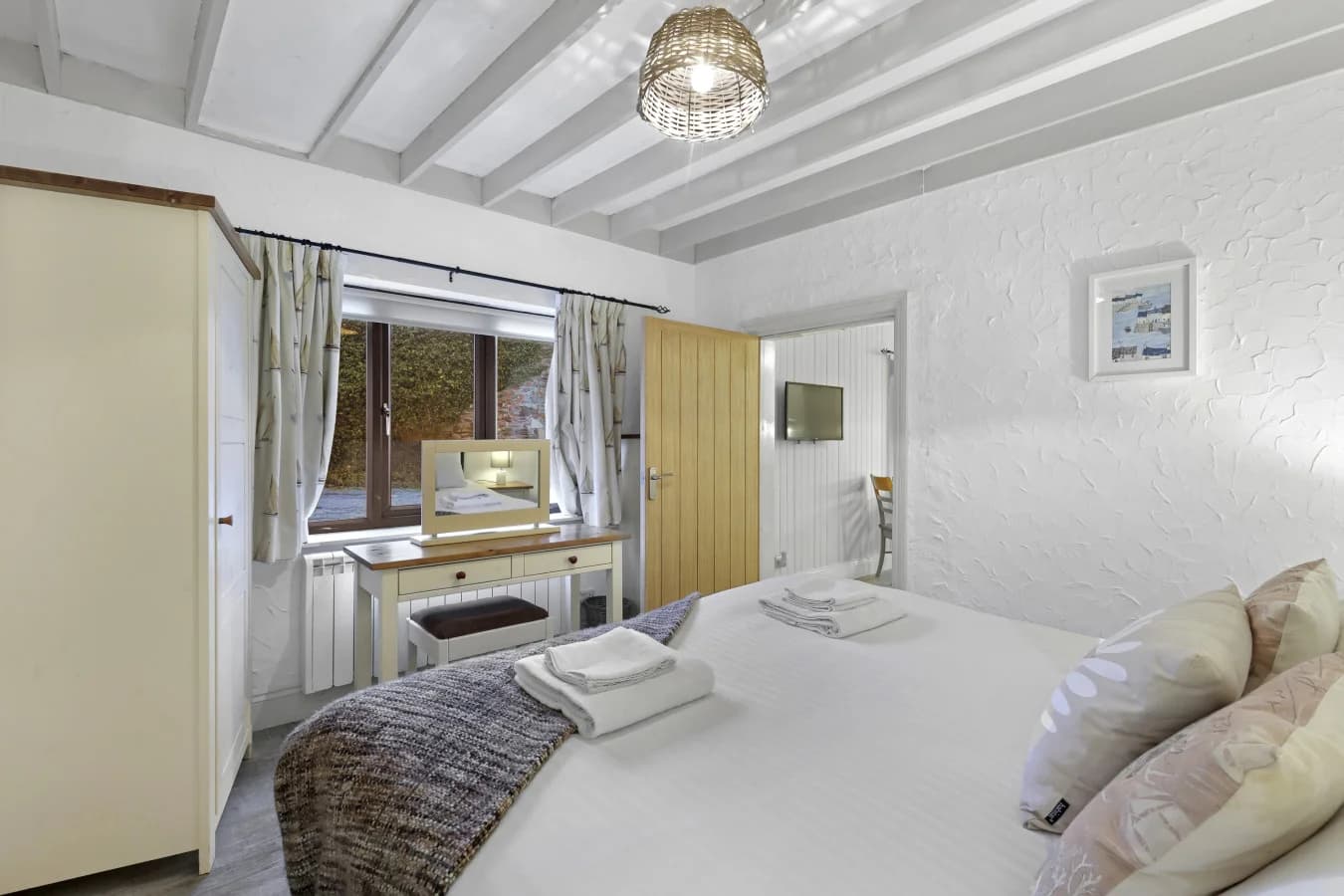 Bedroom overlooking the courtyard with dressing table and wardrobe