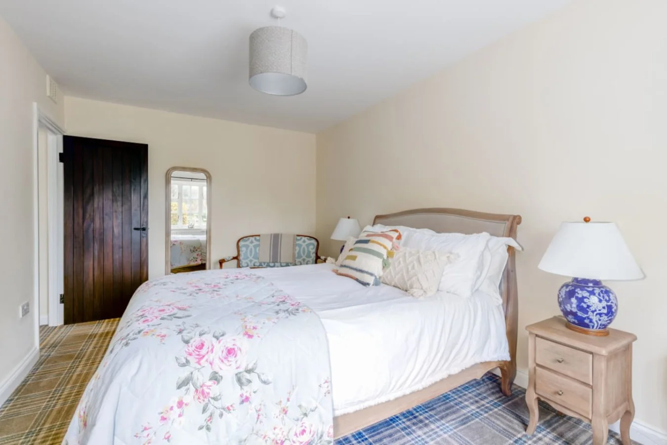 Light-filled king bedroom with soft neutral tones and garden views