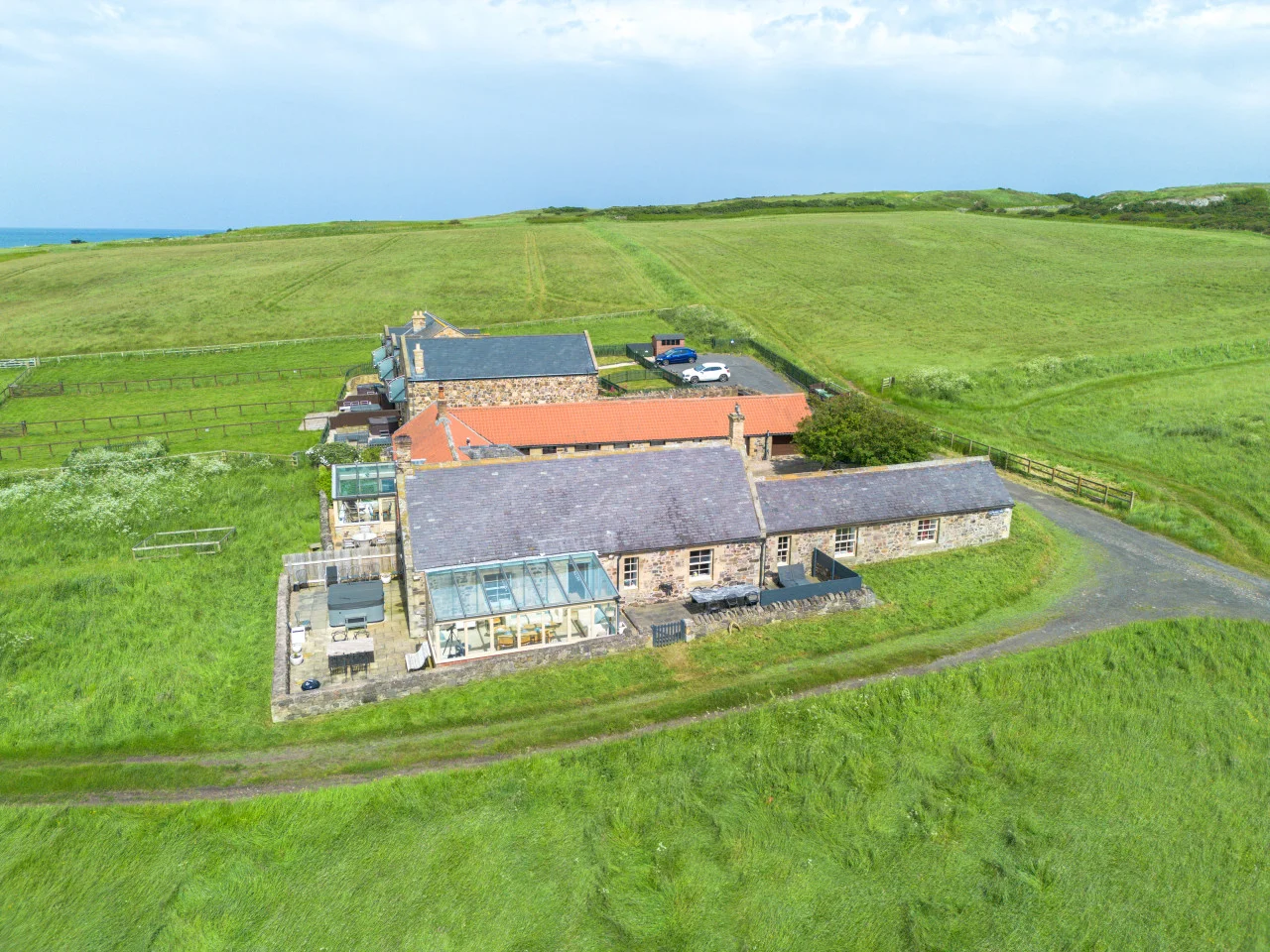 Aerial view of the cottage surrounded by open countryside