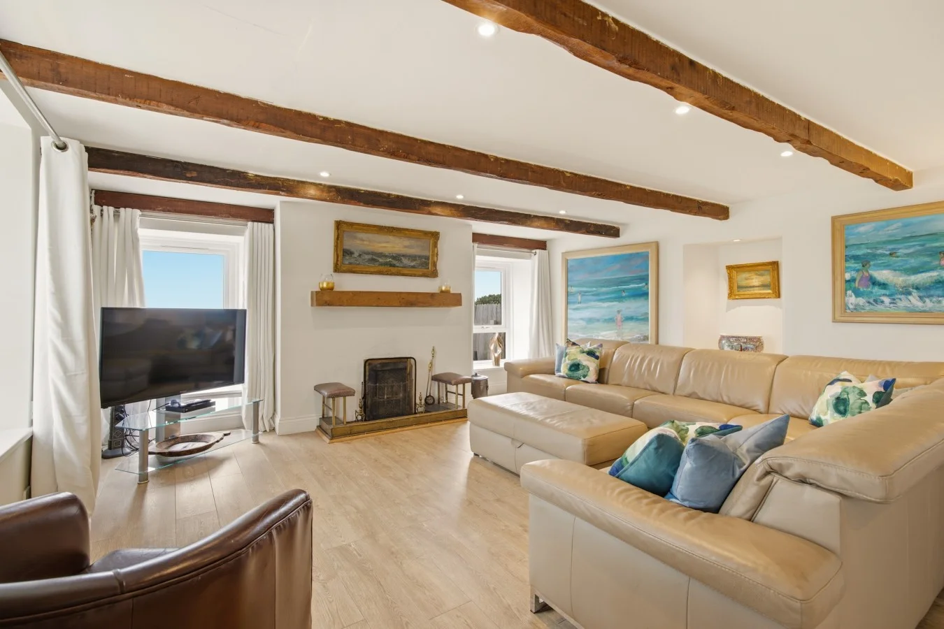 Open-plan living area with exposed beams and oak flooring