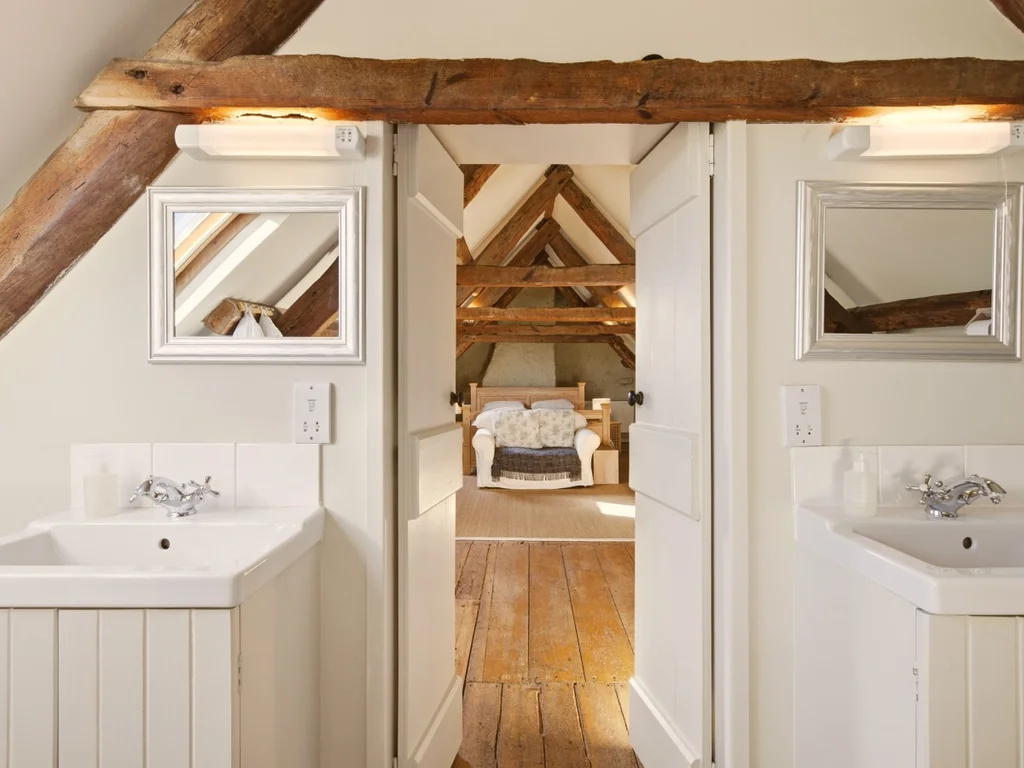 Double washbasins and mirrors in the spacious ensuite bathroom