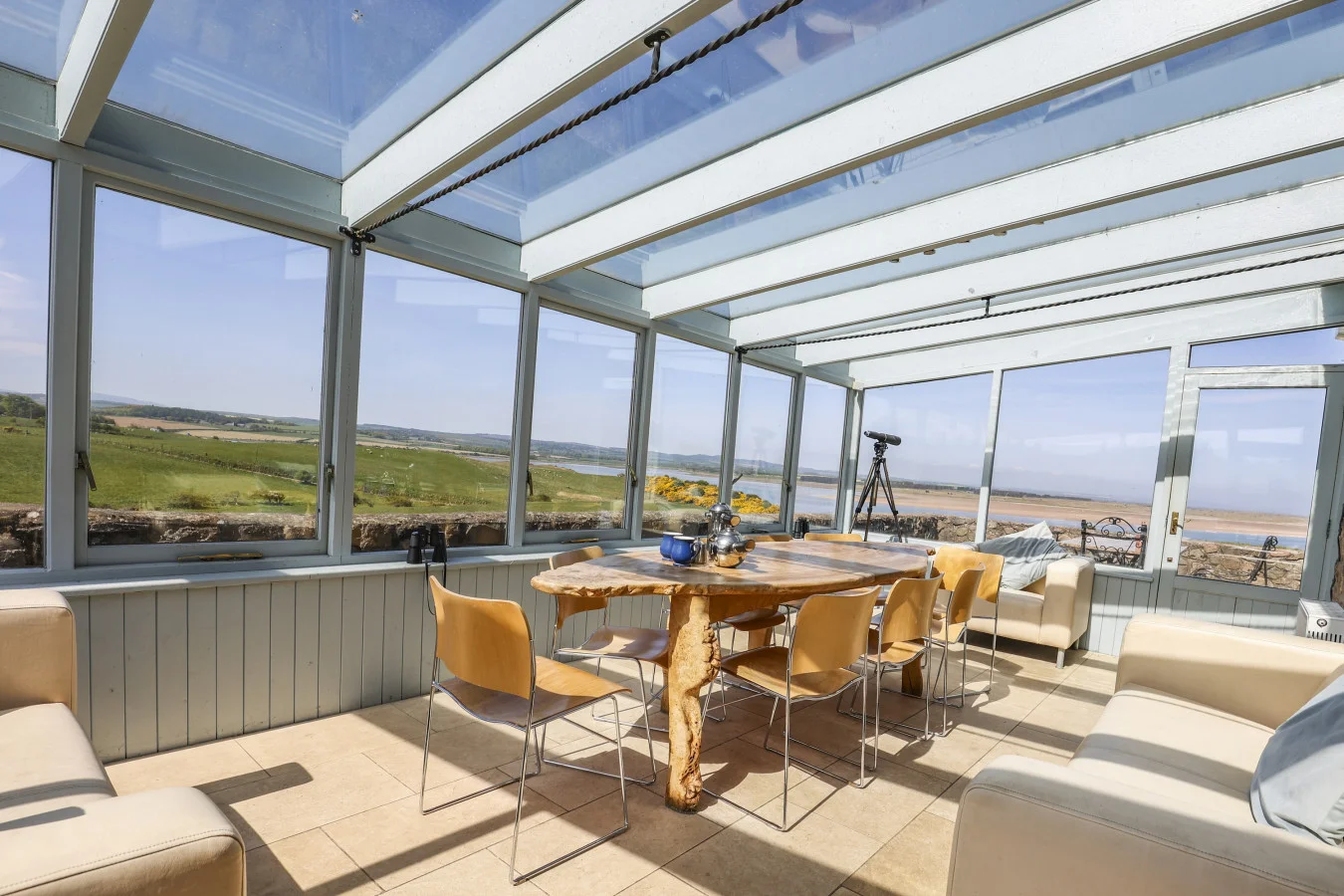 Conservatory dining and seating area with bay views