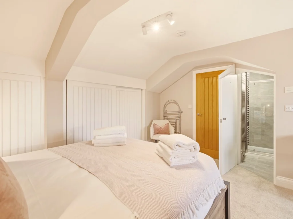 Top-floor king bedroom with built-in wardrobes and en-suite shower room.