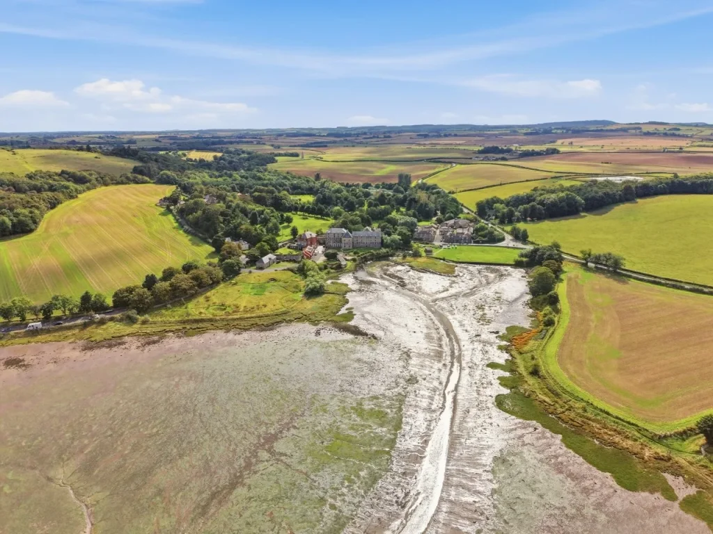 Aerial view over Waren Mill where Waren Burn meets the tidal Budle Bay