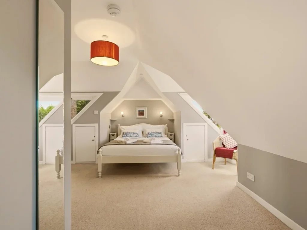 Bright king bedroom with mirrored wardrobe and peaceful countryside outlook