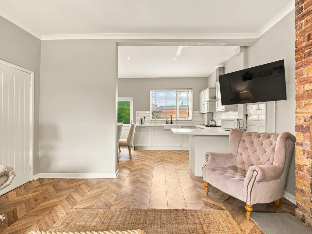 Open-plan living area leading through to the fitted kitchen.