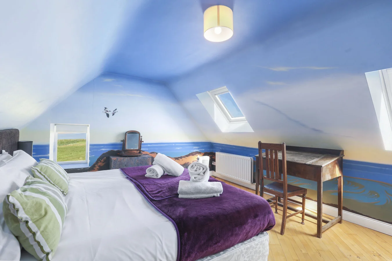 Bedroom with sea views, desk and sloped ceiling