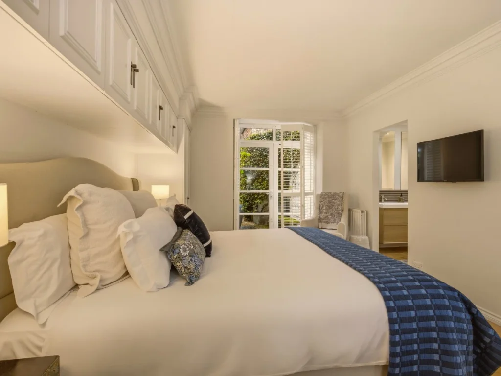 Bright bedroom with a super king bed and comfortable furnishings