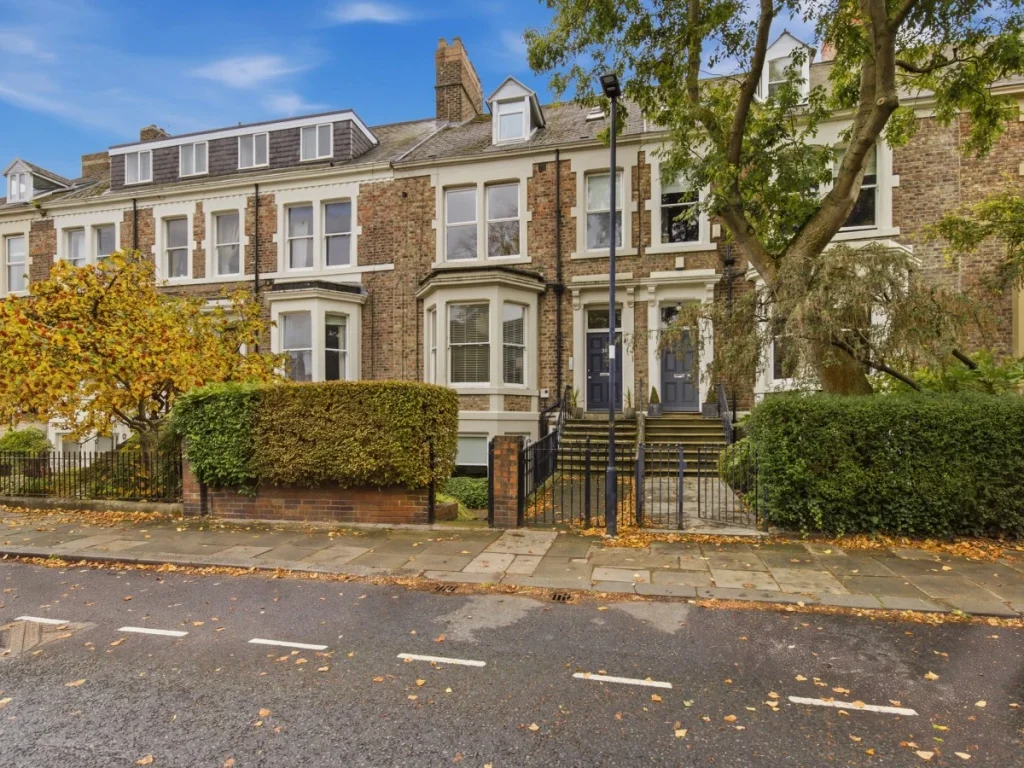 Traditional townhouse frontage with street parking nearby