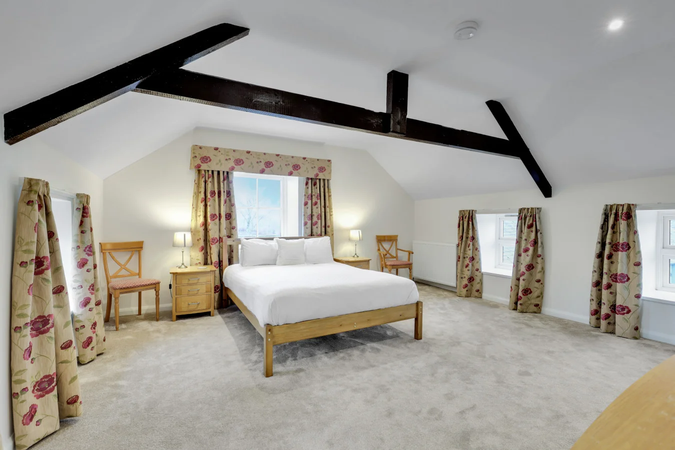 Bright king bedroom combining farmhouse charm and modern comfort