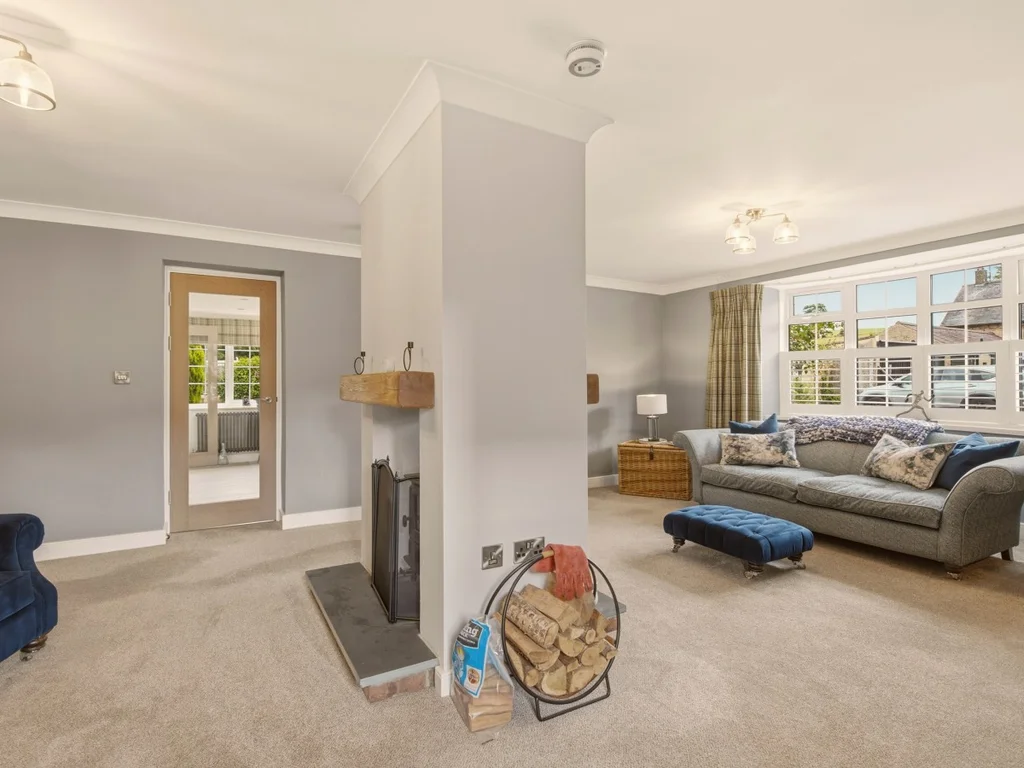 Spacious lounge with central fireplace creating a warm and welcoming focal point
