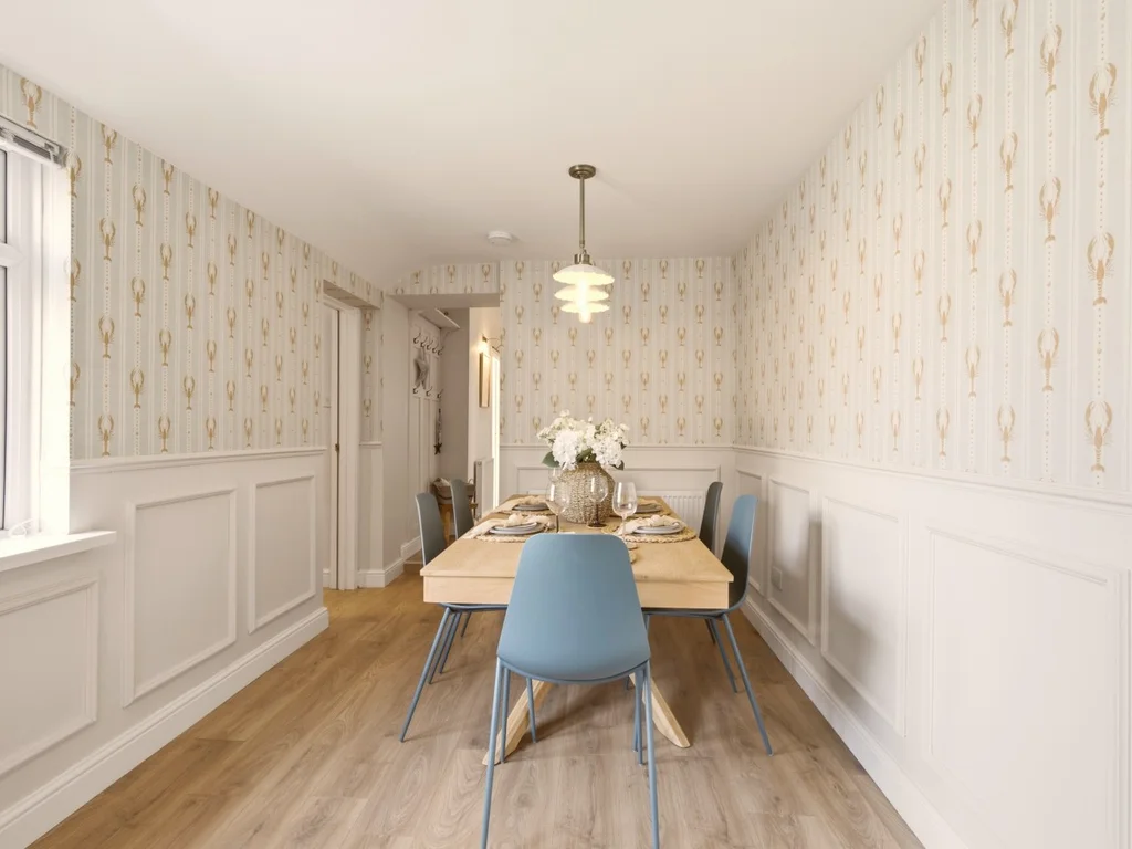 Spacious dining room with wood flooring and six-seat dining table