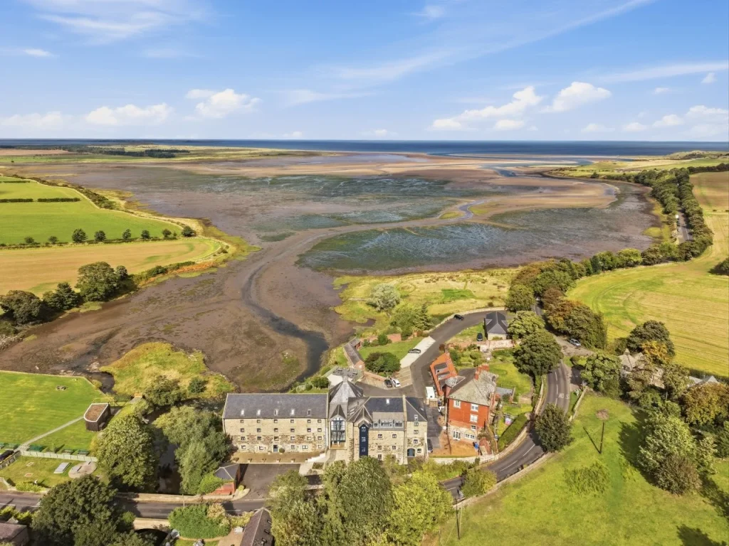 Aerial view of historic Waren Mill overlooking the tidal Budle Bay