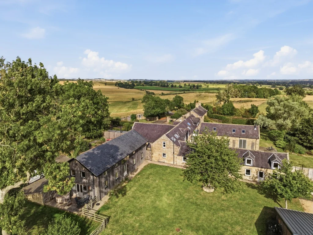 Aerial view of Roses Bower surrounded by rolling countryside
