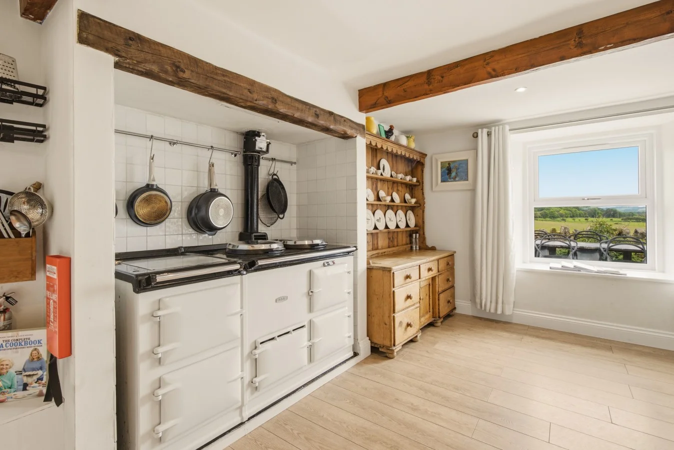 Traditional AGA beneath exposed timber beams with countryside view