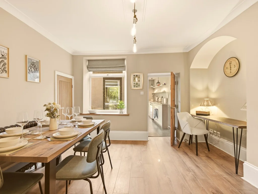 Spacious dining area with seating for six and access to the kitchen.