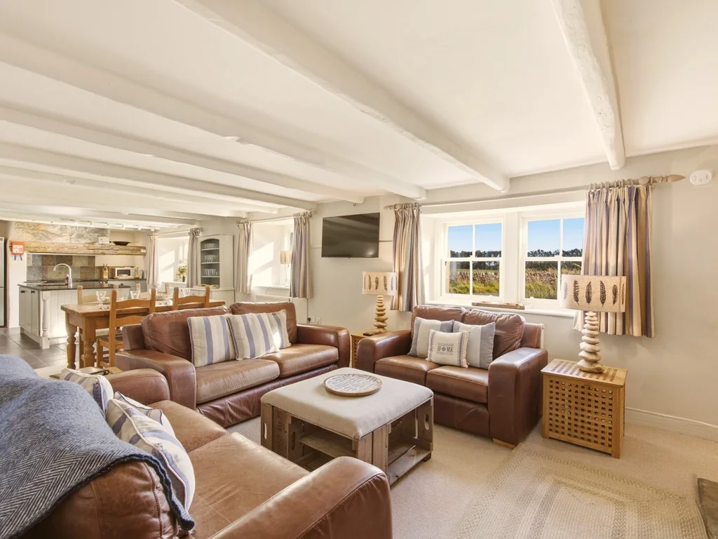 Bright living area with comfortable seating and views of the garden