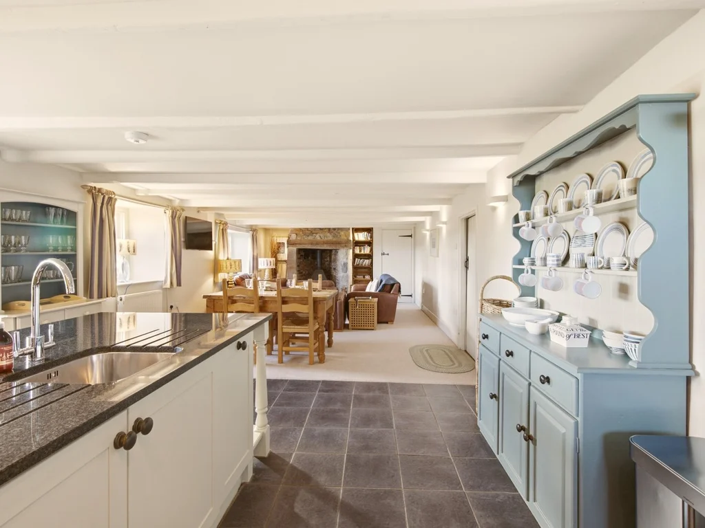 Traditional-style kitchen with a blue dresser and modern appliances