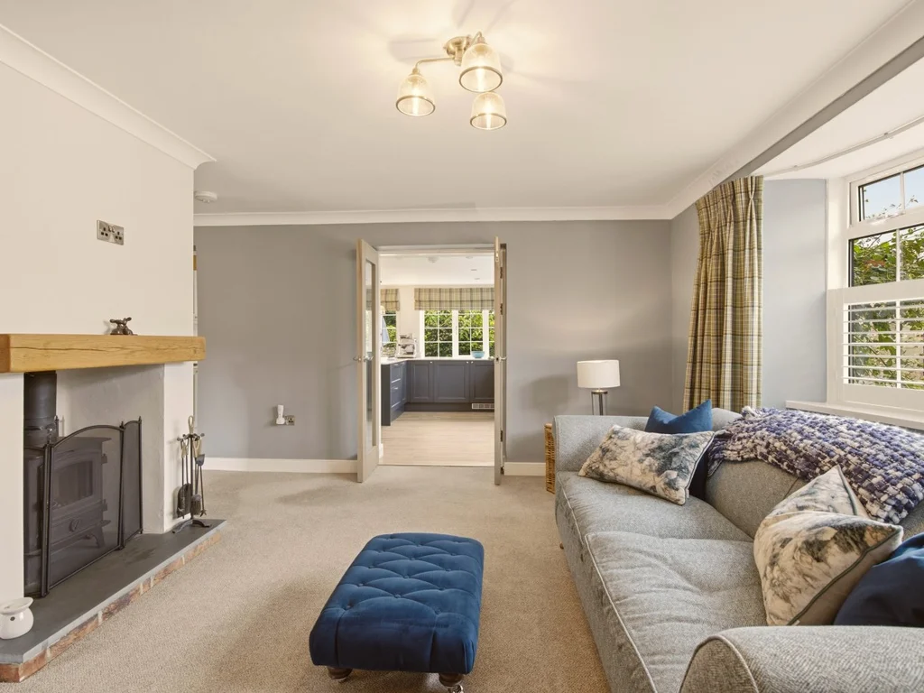 Spacious living room with wood-burning stove and open plan access to the kitchen