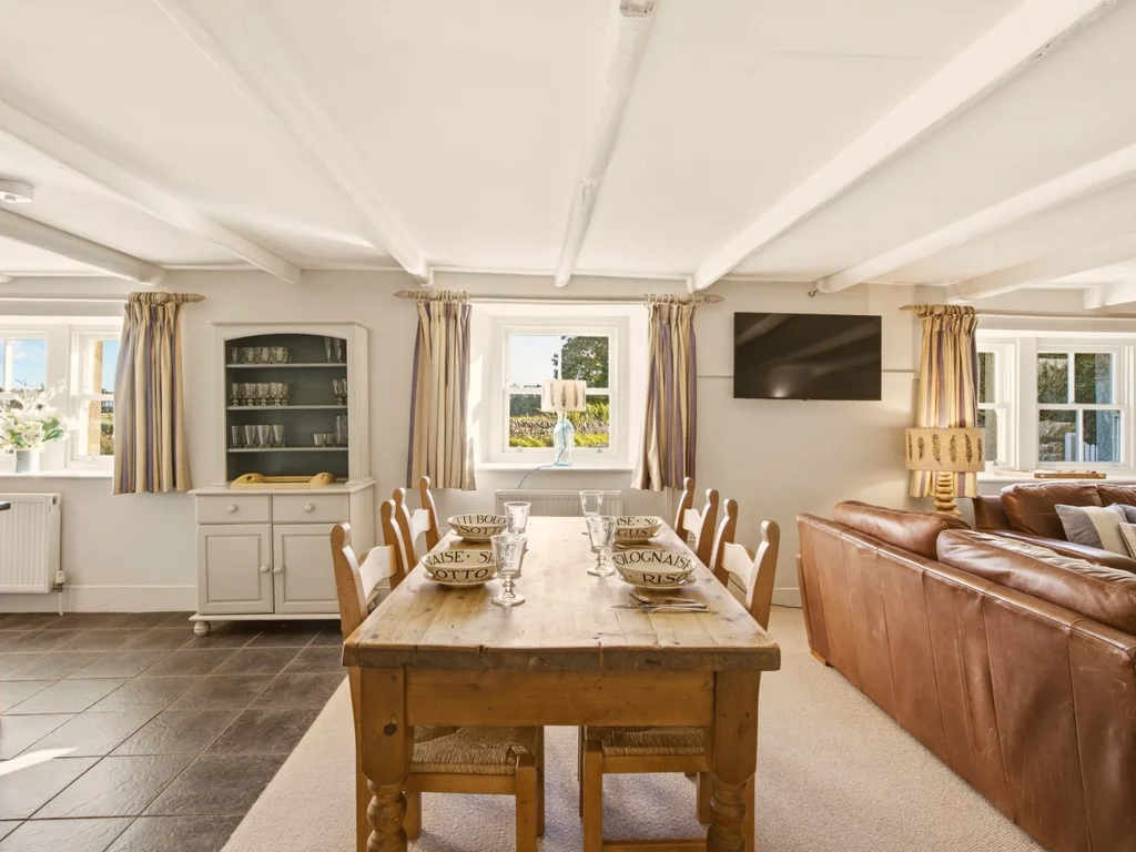 Open-plan dining and living area with rustic character and exposed beams