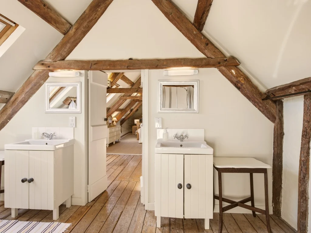 Ensuite bathroom with twin sinks and exposed wooden beams