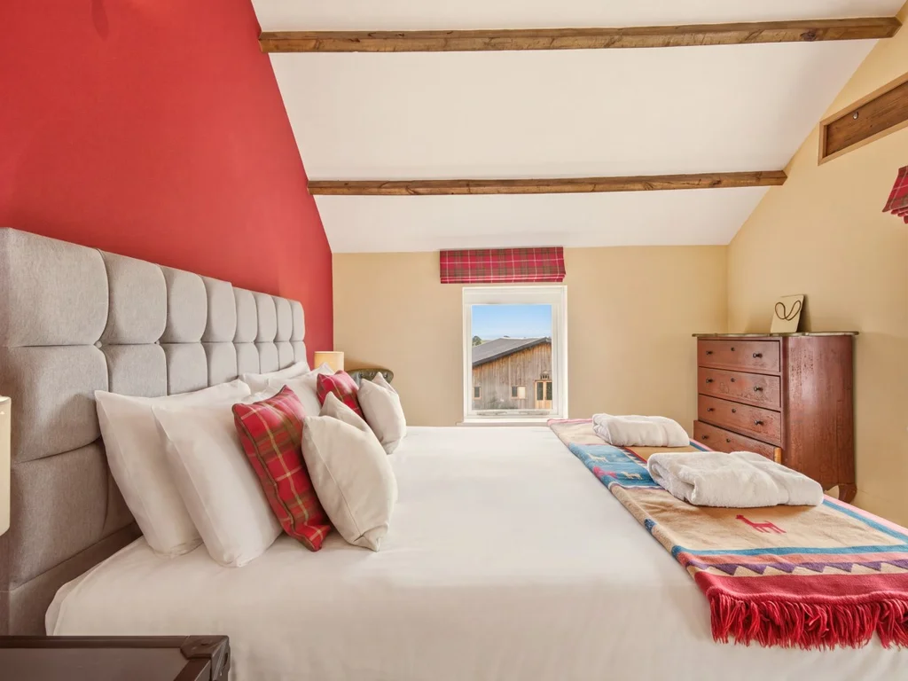 King-size bed with tartan accents, drawers and countryside views