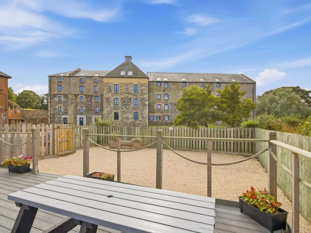 Outdoor seating area with views towards the historic Waren Mill building