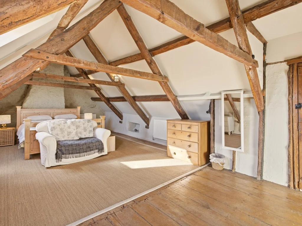 Characterful bedroom with exposed beams and a comfortable bed