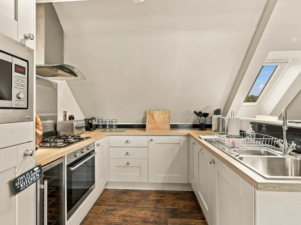 Well-equipped kitchen with integrated appliances and breakfast bar.
