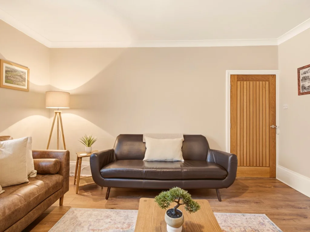 Inviting lounge with leather seating and cosy living space.