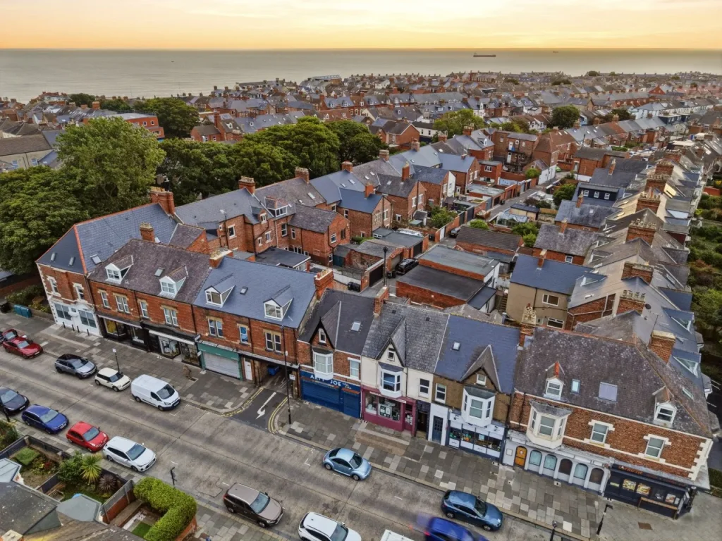 Elevated view of Station Road buildings with the coastline beyond