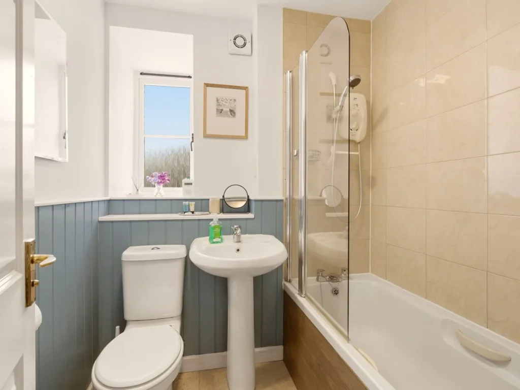 Family bathroom with bath, shower over, pedestal basin and WC