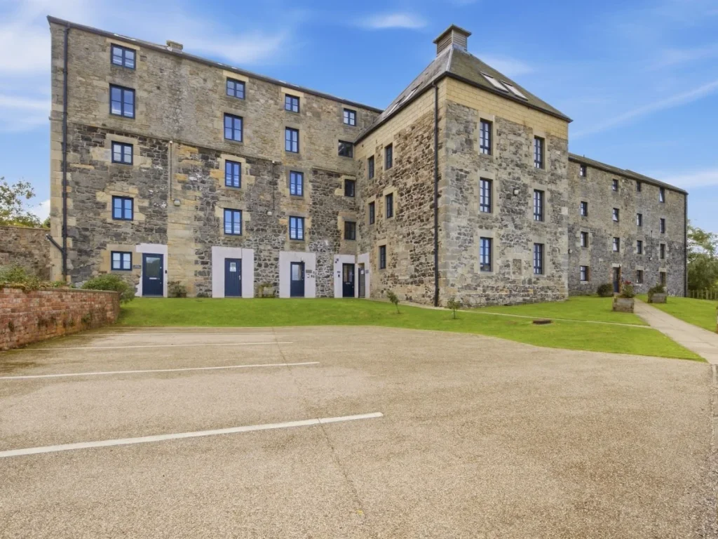 Historic stone exterior of Waren Mill with parking directly outside