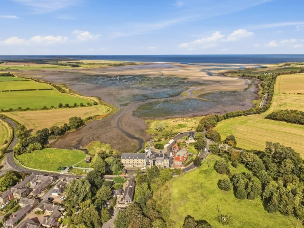 Aerial view across Waren Mill and the sweeping tidal landscape of Budle Bay