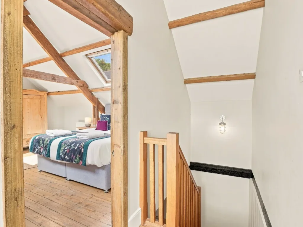 Upper-floor bedroom entrance with exposed timber beams