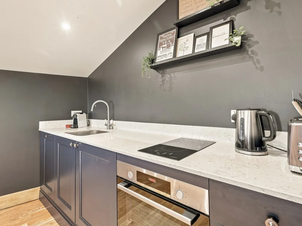 Modern kitchen with induction hob, oven and countertop appliances