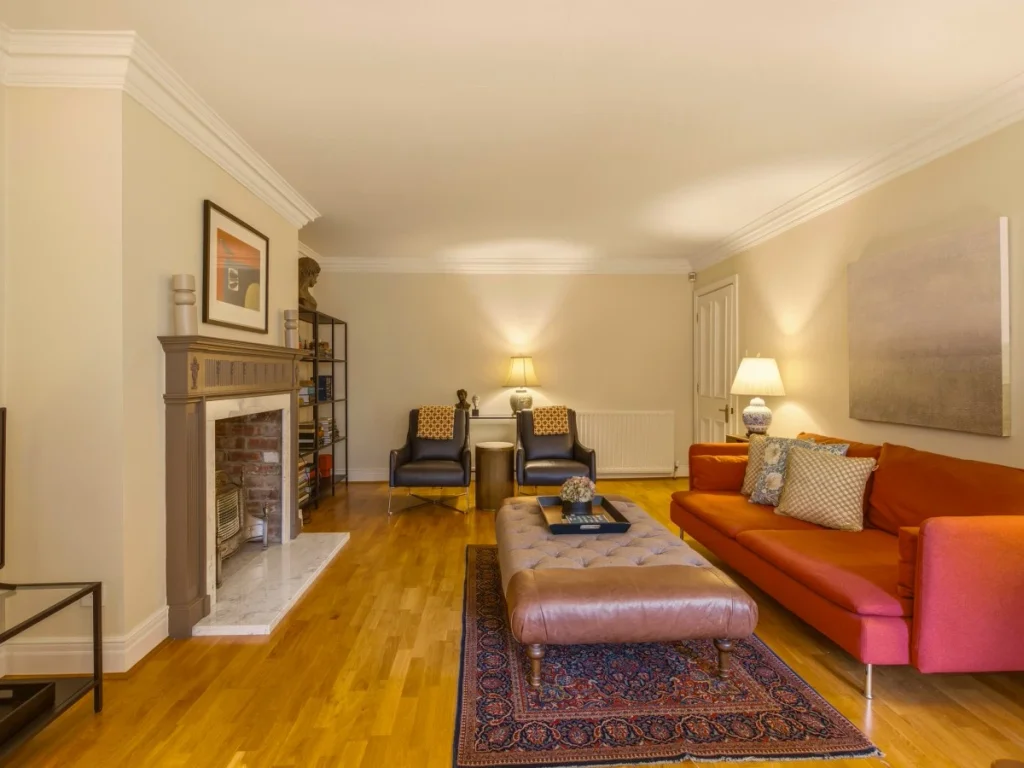 A cosy living space with colourful sofas and a large coffee table