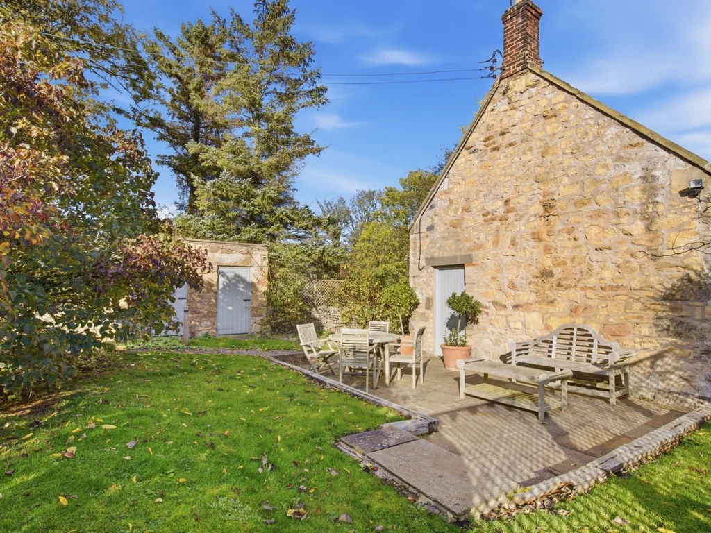 Spitalford's stone exterior and garden with outdoor seating
