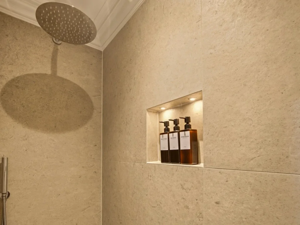 Walk-in shower with a rainfall showerhead and tiled walls