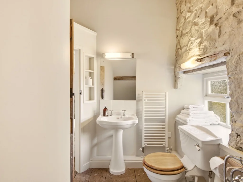 Bathroom with a bath, shower and traditional stonework