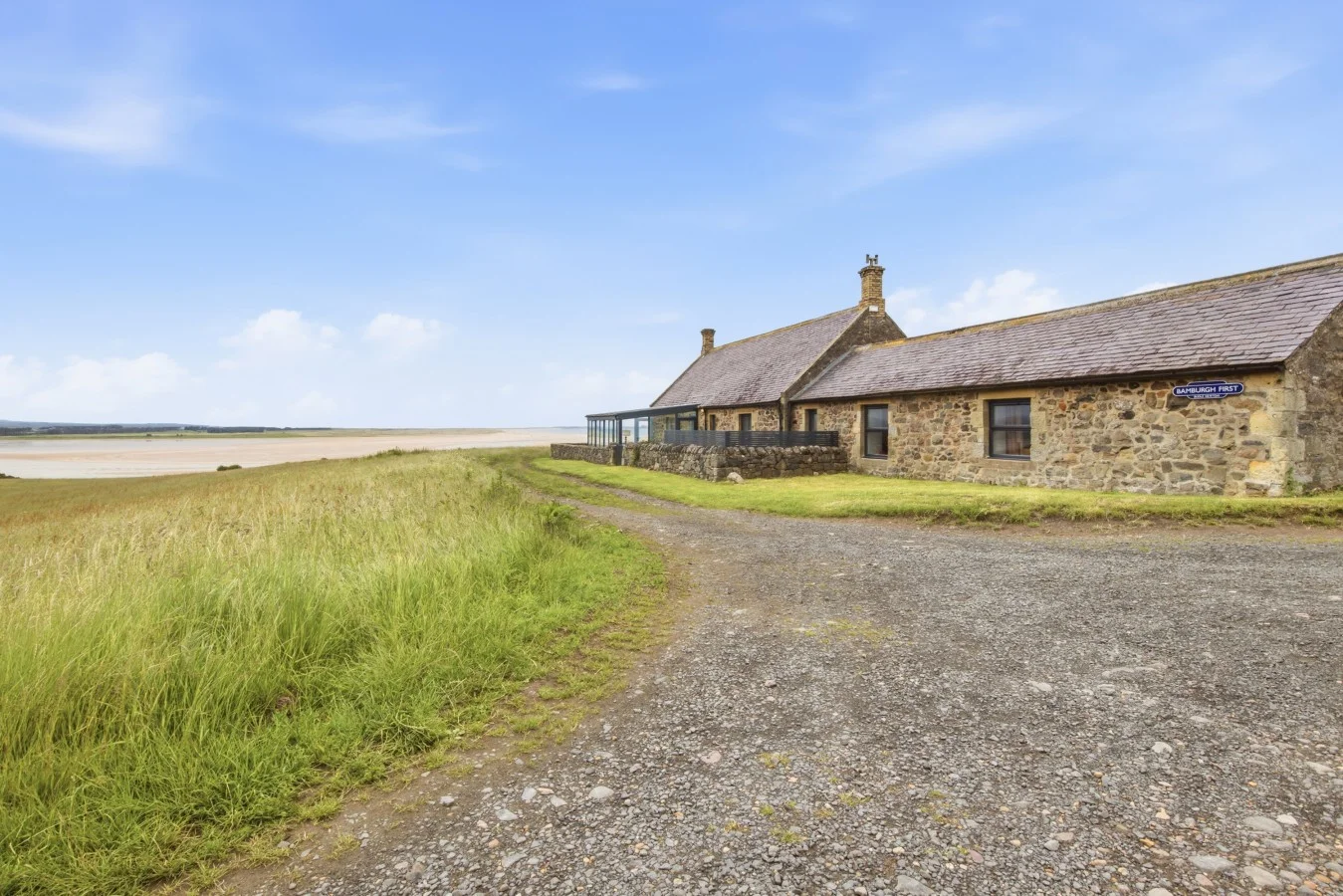 Stone cottage beside Budle Bay with sweeping coastal surroundings