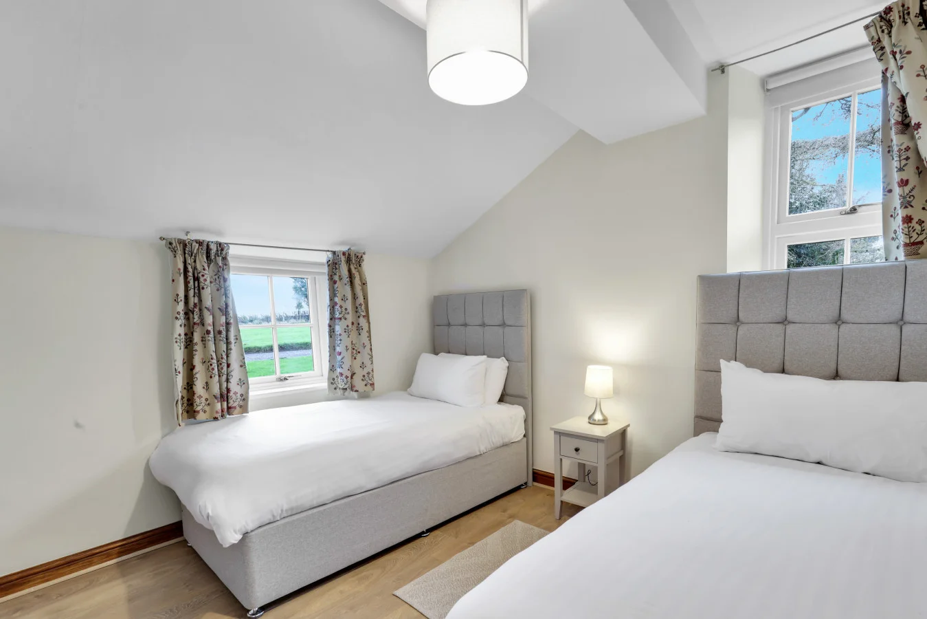 Twin bedroom tucked beneath the eaves with countryside views