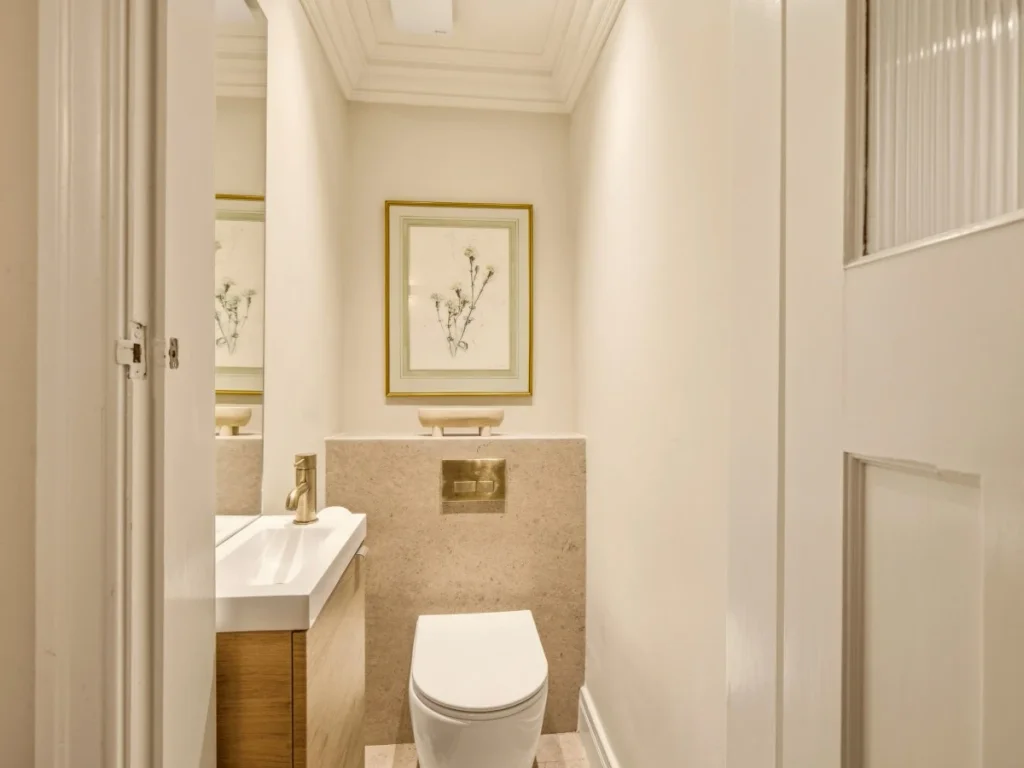 Additional WC with a washbasin and elegant wall decor
