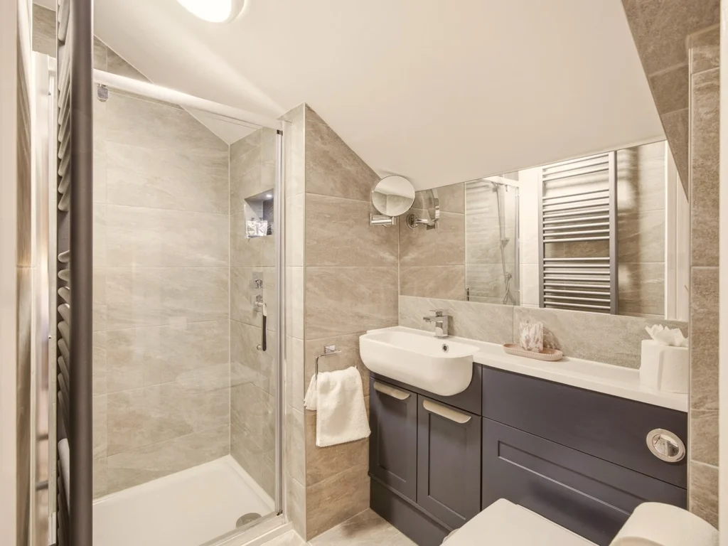 Stylish en-suite shower room with contemporary vanity unit and walk-in shower.