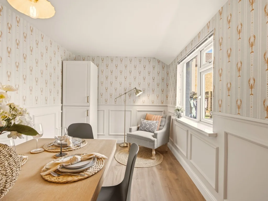 Dining area with window seat, feature wallpaper and natural light