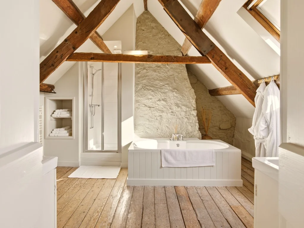 Characterful bedroom with exposed beams and natural stone walls