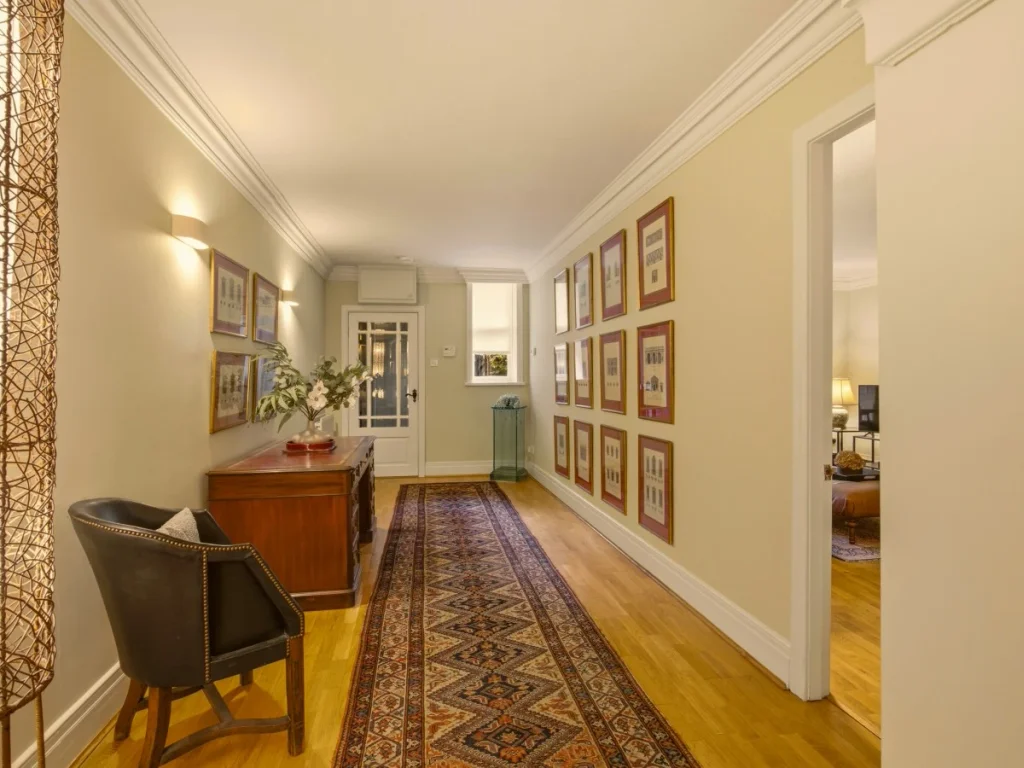 Hallway with a desk, artwork and decorative lighting
